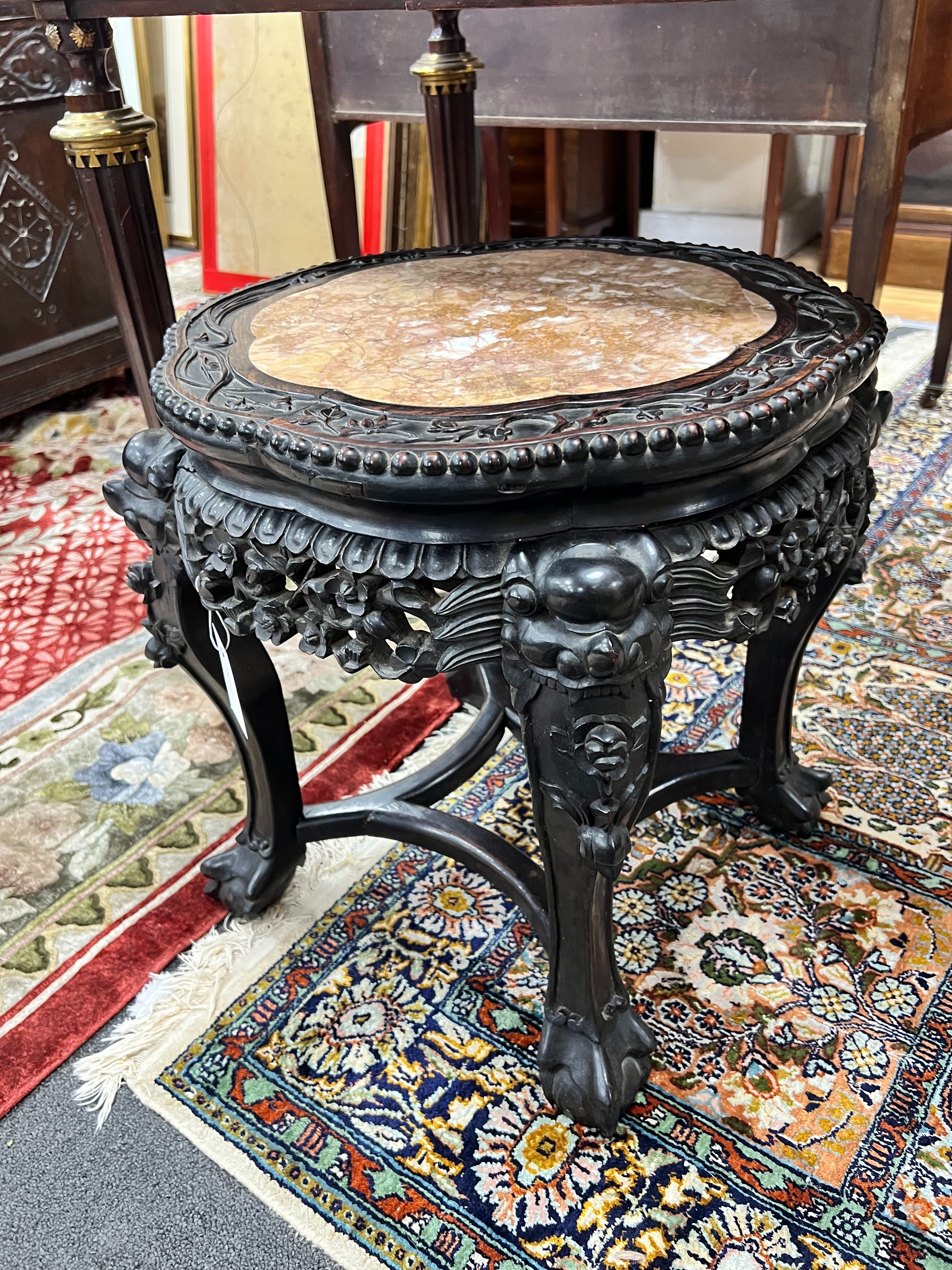 A Chinese circular marble topped jardiniere stand, diameter 42cm height 45cm